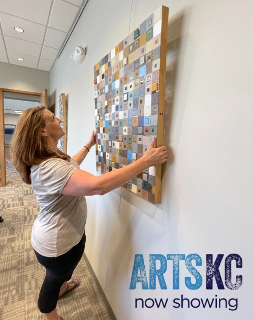 Artist hanging artwork