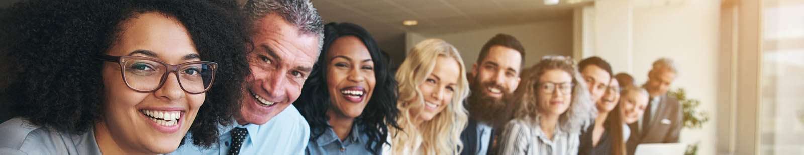 Long row of smiling employees.