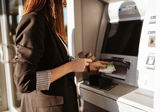 Woman using ATM.