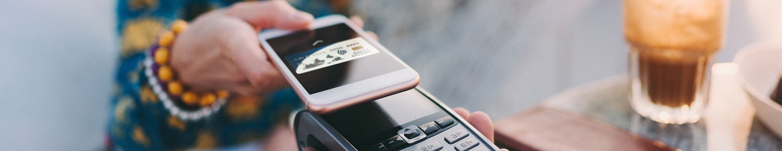 Woman holding phone to make digital payment.