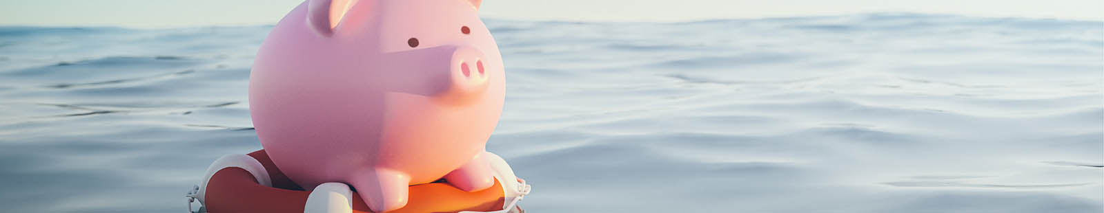 Piggy bank on life preserver in water.