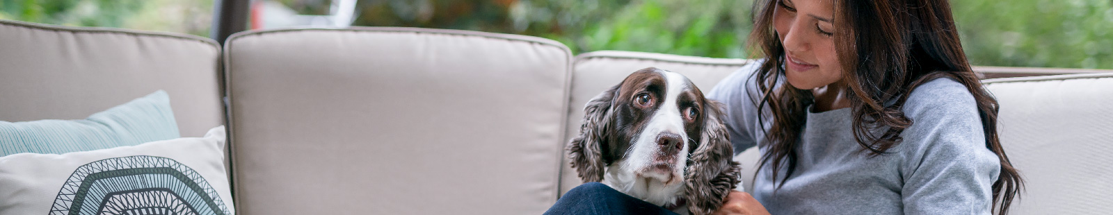 Woman on couch with dog.