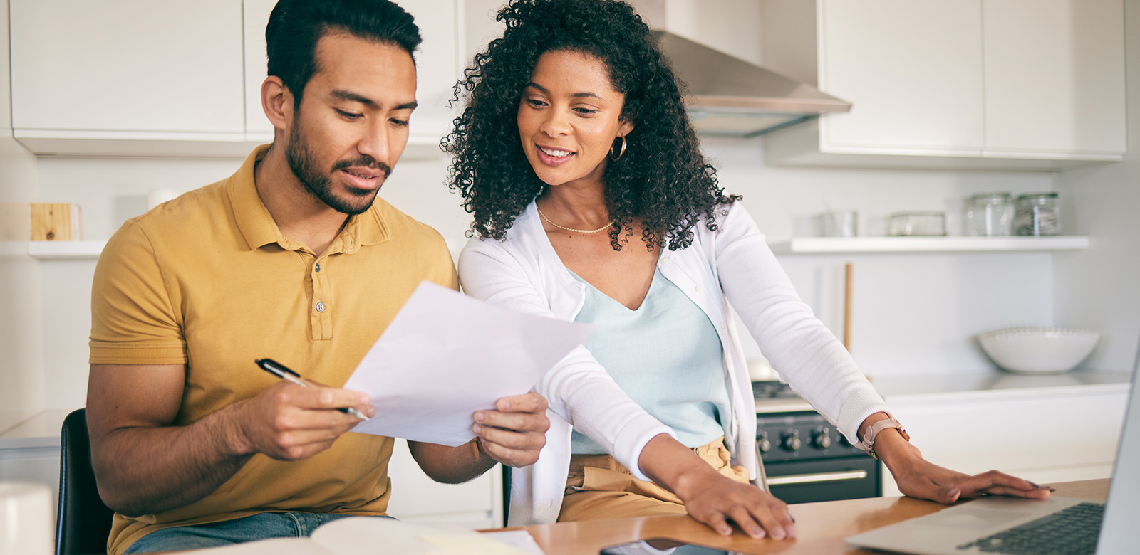 Man and woman looking a bank statement smiling